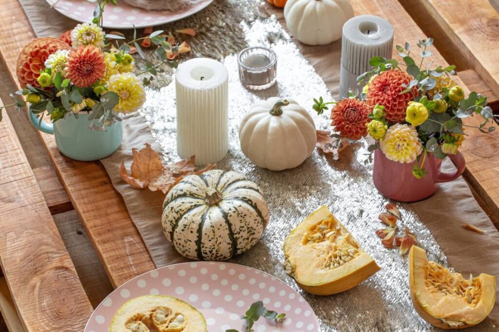 A beautifully set autumn table featuring pastel flower arrangements.